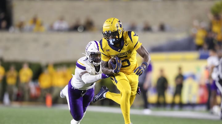 Sep 7, 2024; Morgantown, West Virginia, USA; West Virginia Mountaineers wide receiver Jaden Bray (5) catches a pass and runs for extra yards during the third quarter against the Albany Great Danes at Mountaineer Field at Milan Puskar Stadium. Mandatory Credit: Ben Queen-Imagn Images