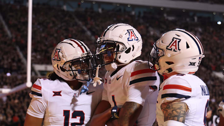 Sep 28, 2024; Salt Lake City, Utah, USA; Arizona Wildcats defensive back Genesis Smith (12) along with defensive back Tacario Davis (1) and defensive back Gunner Maldonado (9) react to a play against the Utah Utes during the second quarter at Rice-Eccles Stadium. Mandatory Credit: Rob Gray-Imagn Images