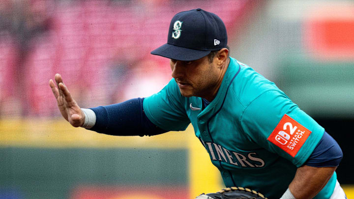 Seattle Mariners first baseman Donovan Solano waives off the pitcher before getting Cincinnati Reds outfielder Jake Fraley (27) out at first in the second inning of the MLB game between Cincinnati Reds and Seattle Mariners at at Great American Ball Park on April 15.