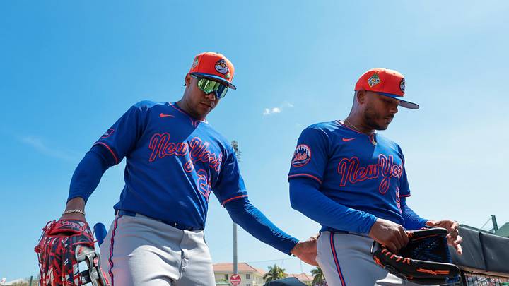 Feb 27, 2026; Jupiter, Florida, USA; New York Mets left fielder Juan Soto (22) and starting pitcher Freddy Peralta (51) return to the dugout against the St. Louis Cardinals after the first inning at Roger Dean Chevrolet Stadium. Mandatory Credit: Sam Navarro-Imagn Images
