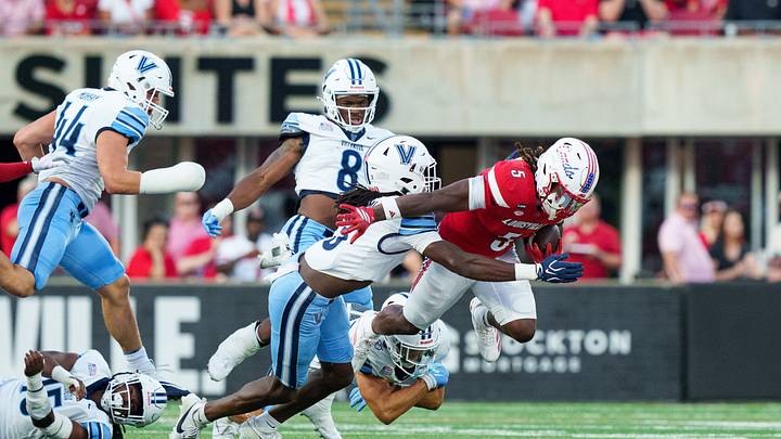 Sep 11, 2026; Louisville, Kentucky, USA; Villanova Wildcats defensive back Josh Oluremi (3) tackles Louisville Cardinals running back Keyjuan Brown (5) during the game against the Louisville Cardinals at L&N Federal Credit Union Stadium. Mandatory Credit: Chris Carter-Imagn Images Sep 11, 2026; Louisville, Kentucky, USA; Villanova Wildcats defensive back Josh Oluremi (3) tackles Louisville Cardinals running back Keyjuan Brown (5) during the game against the Louisville Cardinals at L&N Federal Credit Union Stadium. Mandatory Credit: Chris Carter-Imagn Images