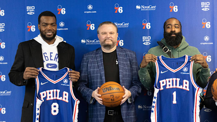 Feb 15, 2022; Camden, NJ, USA; Philadelphia 76ers forward Paul Millsap (8) and guard James Harden (1) and president of basketball operations Daryl Morey (M) pose for a photo after speaking with the media at Philadelphia 76ers Training Complex. Mandatory Credit: Bill Streicher-Imagn Images