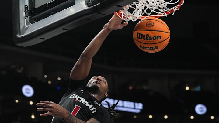 Bearcats Day Day Thomas (1) leaps and scores during Game 1 of the 2025 Phillips 66 Big 12 Basketball Championship against the Oklahoma State Cowboys at the T-Mobile Center in Kansas City, Missouri on Tuesday March 11, 2025. Bearcats lead the game at halftime with a score of 38-26. Bearcats Day Day Thomas (1) leaps and scores during Game 1 of the 2025 Phillips 66 Big 12 Basketball Championship against the Oklahoma State Cowboys at the T-Mobile Center in Kansas City, Missouri on Tuesday March 11, 2025. Bearcats lead the game at halftime with a score of 38-26.