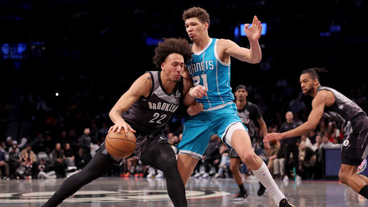 Feb 10, 2025; Brooklyn, New York, USA; Brooklyn Nets forward Jalen Wilson (22) controls the ball against Charlotte Hornets forward Tidjane Salaun (31) during the fourth quarter at Barclays Center. Mandatory Credit: Brad Penner-Imagn Images