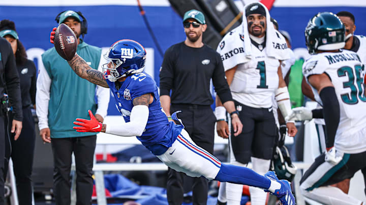 Oct 20, 2024; East Rutherford, New Jersey, USA; New York Giants wide receiver Jalin Hyatt (13) attempts to catch a pass in front of Philadelphia Eagles safety Tristin McCollum (36) during the second half at MetLife Stadium.  