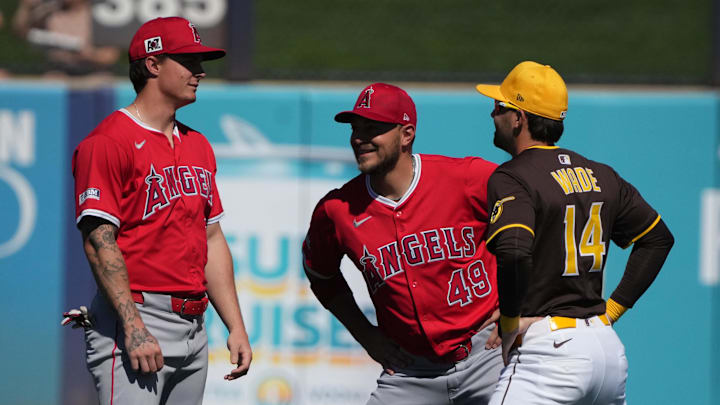 Angels right fielder Mickey Moniak (left) and designated hitter Ryan Noda (49) talk to San Diego Padres infielder Tyler Wade (14) before a game at Peoria Sports Complex. 