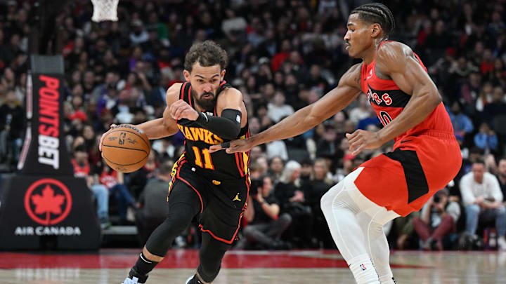 Dec 29, 2024; Toronto, Ontario, CAN; Atlanta Hawks guard Trae Young (11) dribbles the ball past Toronto Raptors guard Ochai Agbaji (30) in the first half at Scotiabank Arena. Mandatory Credit: Dan Hamilton-Imagn Images Dec 29, 2024; Toronto, Ontario, CAN; Atlanta Hawks guard Trae Young (11) dribbles the ball past Toronto Raptors guard Ochai Agbaji (30) in the first half at Scotiabank Arena. Mandatory Credit: Dan Hamilton-Imagn Images