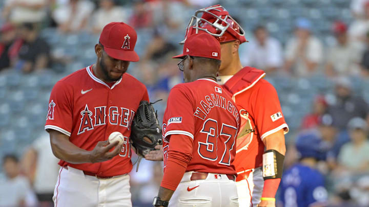 Jul 9, 2024; Anaheim, California, USA; Los Angeles Angels catcher Logan O'Hoppe (14) looks on as manager Ron Washington (37) pulls starting pitcher Roansy Contreras (57) in the third inning against the Texas Rangers at Angel Stadium. Mandatory Credit: Jayne Kamin-Oncea-Imagn Images Jul 9, 2024; Anaheim, California, USA; Los Angeles Angels catcher Logan O'Hoppe (14) looks on as manager Ron Washington (37) pulls starting pitcher Roansy Contreras (57) in the third inning against the Texas Rangers at Angel Stadium. Mandatory Credit: Jayne Kamin-Oncea-Imagn Images