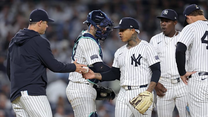 Sep 25, 2024; Bronx, New York, USA; New York Yankees manager Aaron Boone (17) takes the ball from starting pitcher Marcus Stroman (0) during the fourth inning against the Baltimore Orioles at Yankee Stadium. Mandatory Credit: Brad Penner-Imagn Images