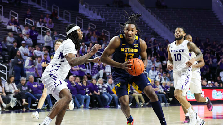 Mar 3, 2026; Manhattan, Kansas, USA; West Virginia Mountaineers guard Chance Moore (13) drives the lane against Kansas State Wildcats guard C.J. Jones (3) during the first half at Bramlage Coliseum. Mandatory Credit: Scott Sewell-Imagn Images