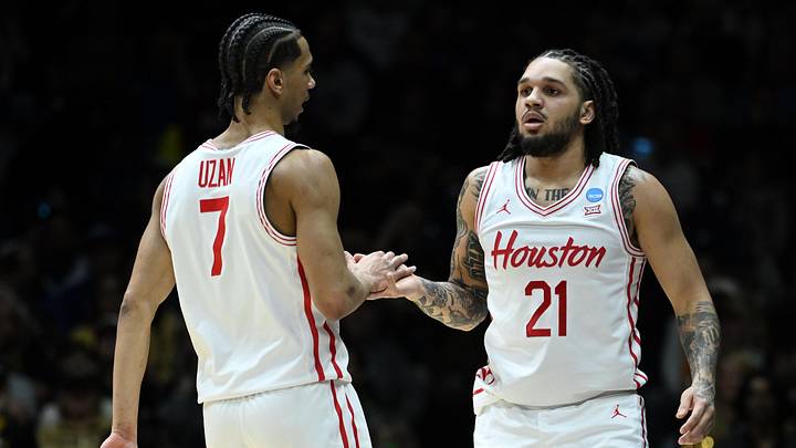 Mar 28, 2025; Indianapolis, IN, USA; Houston Cougars guard Emanuel Sharp (21) reacts with guard Milos Uzan (7) in the first half during a Midwest Regional semifinal of the 2025 NCAA tournament at Lucas Oil Stadium. Mandatory Credit: Robert Goddin-Imagn Images