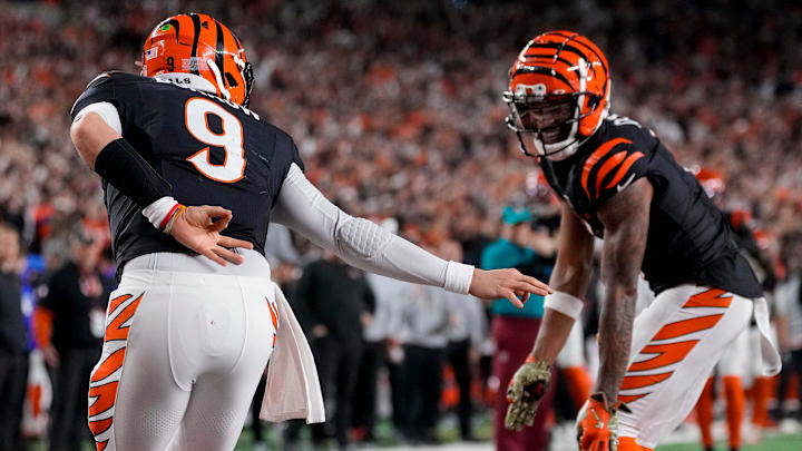 Cincinnati Bengals quarterback Joe Burrow (9) celebrates a touchdown on a QB sneak up the middle in the fourth quarter of the NFL Week 17 game between the Cincinnati Bengals and the Denver Broncos at Paycor Stadium in downtown Cincinnati on Saturday, Dec. 28, 2024. The Bengals took a 30-24 win in overtime to remain in the post season chase.