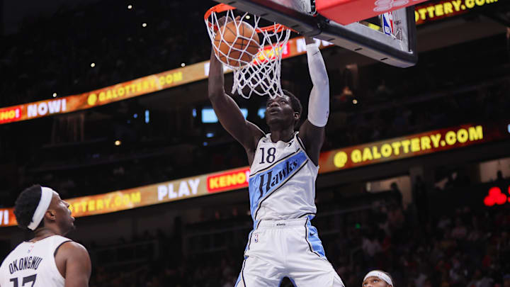 Mar 23, 2025; Atlanta, Georgia, USA; Atlanta Hawks forward Mouhamed Gueye (18) dunks against the Philadelphia 76ers in the third quarter at State Farm Arena. Mandatory Credit: Brett Davis-Imagn Images