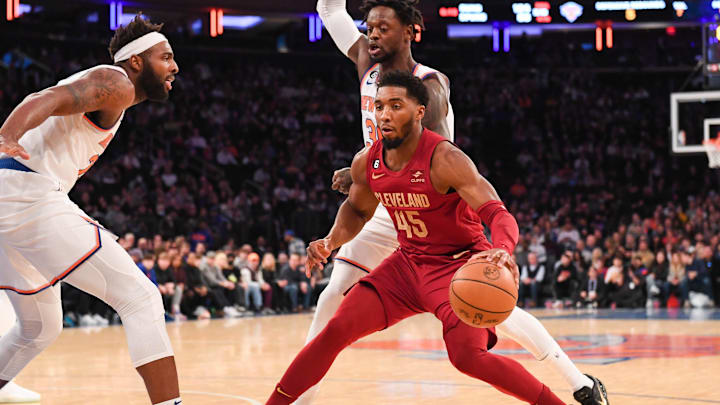 Dec 4, 2022; New York, New York, USA;  New York Knicks center Mitchell Robinson (23) attempts to stop Cleveland Cavaliers guard Donovan Mitchell (45) during the first quarter at Madison Square Garden. Mandatory Credit: Dennis Schneidler-Imagn Images