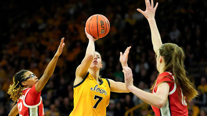 Iowa guard Addie Deal (7) drives toward the basket against Ohio State guard Jaloni Cambridge (22) and Ohio State center Elsa Lemmilä (12) Jan. 25, 2026 at Carver-Hawkeye Arena in Iowa City, Iowa.