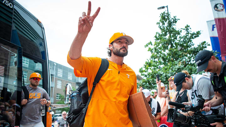 Tennessee head coach Tony Vitello acknowledges the fans lined up for the team's arrival before game one of the NCAA College World Series finals between Tennessee and Texas A&M at Charles Schwab Field in Omaha, Neb., on Saturday, June 22, 2024.