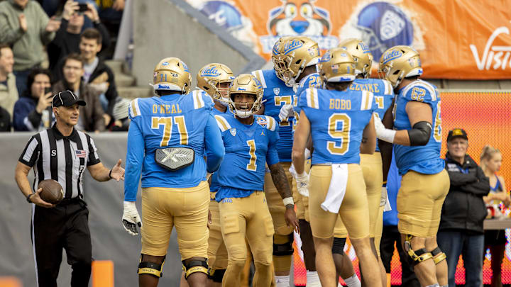 Dec 30, 2022; El Paso, Texas, USA; UCLA Bruins quarterback Dorian Thompson-Robinson (1) celebrates with teammates after scoring a touchdown run against the Pittsburgh Panthers defense in the first half in the 2022 Sun Bowl at Sun Bowl. Mandatory Credit: Ivan Pierre Aguirre-Imagn Images