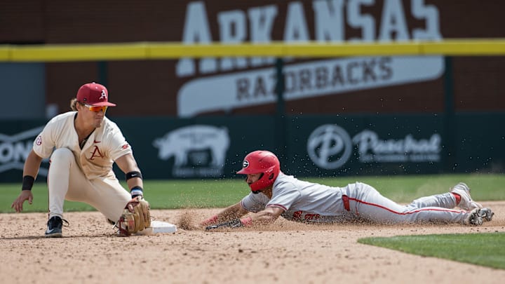 Apr 18, 2026; Fayetteville, AR, USA; Georgia Bulldogs infielder Kolby Branch (9) slides in safe for a stolen base as Arkansas Razorbacks infielder Camden Kozeal (8) can’t make the tag in time during the sixth inning at Baum-Walker Stadium. Georgia won 26-14. Mandatory Credit: Brett Rojo-Imagn Images