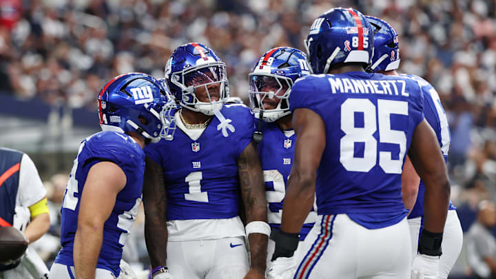 Sep 14, 2025; Arlington, Texas, USA; New York Giants wide receiver Malik Nabers (1) celebrates with teammates after scoring a touchdown against the Dallas Cowboys during the second quarter at AT&T Stadium. Mandatory Credit: Kevin Jairaj-Imagn Images