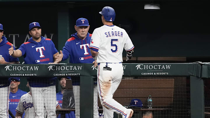 Texas Rangers shortstop Corey Seager (5) celebrates his solo home run with manager Bruce Bochy (15) against the Los Angeles Angels during the seventh inning at Globe Life Field. Seager’s home run was his 100th as a Texas Ranger on April 17.