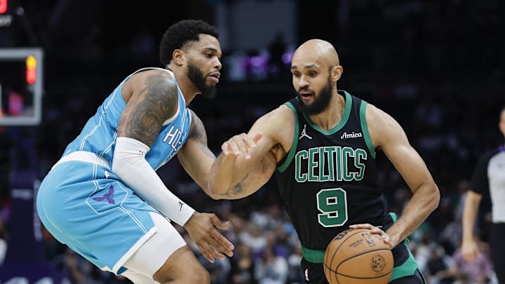 Nov 2, 2024; Charlotte, North Carolina, USA; Boston Celtics guard Derrick White (9) drives against Charlotte Hornets forward Miles Bridges during the first quarter at Spectrum Center. Mandatory Credit: Nell Redmond-Imagn Images