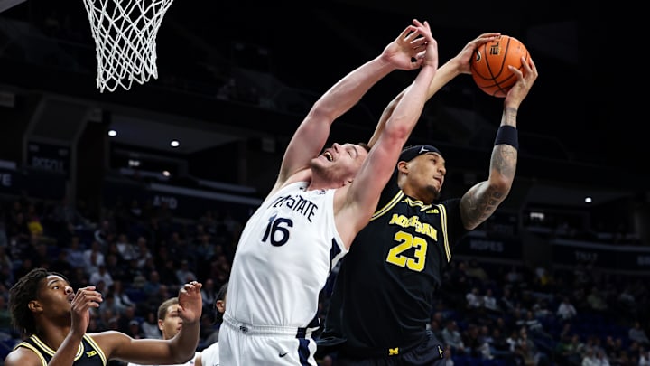 Jan 6, 2026; University Park, Pennsylvania, USA; Michigan Wolverines forward Yaxel Lendeborg (23) grabs the rebound over Penn State Nittany Lions forward Tibor Mirtic (16) during the first half at Bryce Jordan Center. Mandatory Credit: Matthew O'Haren-Imagn Images Jan 6, 2026; University Park, Pennsylvania, USA; Michigan Wolverines forward Yaxel Lendeborg (23) grabs the rebound over Penn State Nittany Lions forward Tibor Mirtic (16) during the first half at Bryce Jordan Center. Mandatory Credit: Matthew O'Haren-Imagn Images