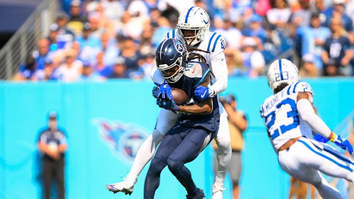 Oct 13, 2024; Nashville, Tennessee, USA;  Indianapolis Colts cornerback Jaylon Jones (40) tackles Tennessee Titans wide receiver DeAndre Hopkins (10) after a made catch during the first half at Nissan Stadium. Mandatory Credit: Steve Roberts-Imagn Images