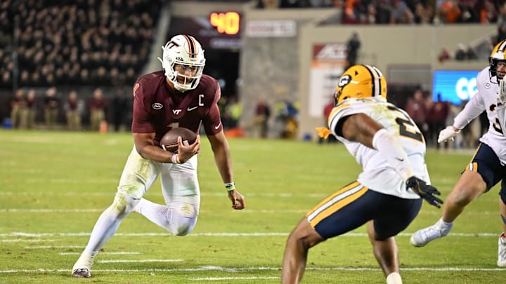 Oct 24, 2025; Blacksburg, Virginia, USA;  Virginia Tech Hokies quarterback Kyron Drones (1) runs the ball for a two point conversion during the second overtime period as California Golden Bears defensive back Dru Polidore Jr. (2)defends at Lane Stadium. Mandatory Credit: Brian Bishop-Imagn Images