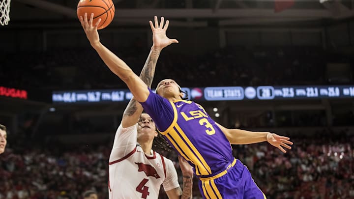 Feb 12, 2025; Fayetteville, Arkansas, USA; LSU Tigers guard Curtis Givens III (3) tries a layup past Arkansas Razorbacks forward Trevon Brazile (4) during the first half at Bud Walton Arena. Arkansas won 70-58. Mandatory Credit: Brett Rojo-Imagn Images Feb 12, 2025; Fayetteville, Arkansas, USA; LSU Tigers guard Curtis Givens III (3) tries a layup past Arkansas Razorbacks forward Trevon Brazile (4) during the first half at Bud Walton Arena. Arkansas won 70-58. Mandatory Credit: Brett Rojo-Imagn Images