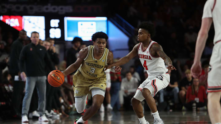 Nov 14, 2025; Athens, Georgia, USA; Georgia Tech Yellow Jackets guard Jaeden Mustaf (3) dribbles past Georgia Bulldogs guard Marcus Millender (4) during the second half at Stegeman Coliseum. Mandatory Credit: Mady Mertens-Imagn Images