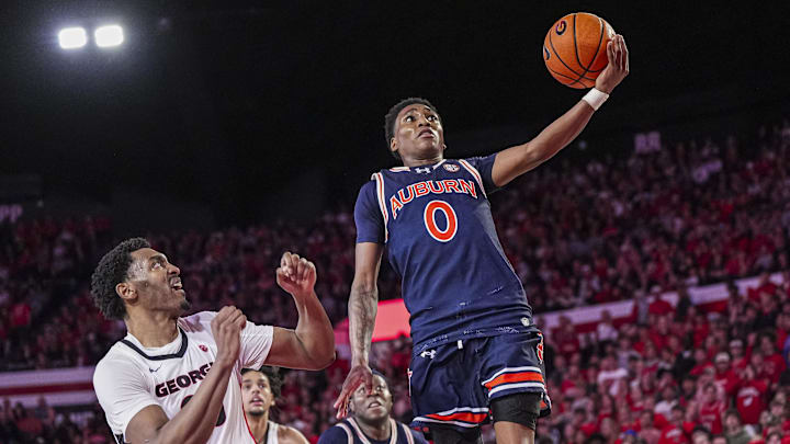 Jan 18, 2025; Athens, Georgia, USA; Auburn Tigers guard Tahaad Pettiford (0) goes to the basket past Georgia Bulldogs forward Justin Abson (25) at Stegeman Coliseum. Mandatory Credit: Dale Zanine-Imagn Images