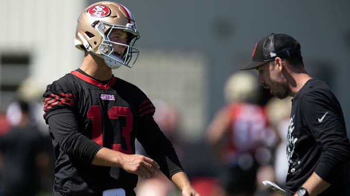 Jul 26, 2024; Santa Clara, CA, USA; San Francisco 49ers quarterback Brock Purdy (13) talks with a coach during Day 4 of training camp at SAP Performance Facility. Mandatory Credit: D. Ross Cameron-Imagn Images