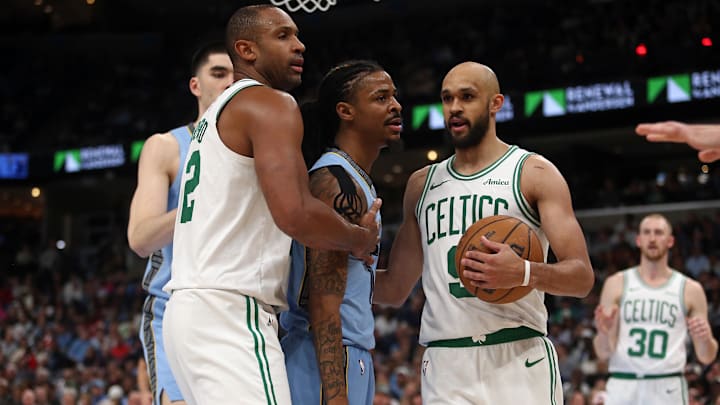 Mar 31, 2025; Memphis, Tennessee, USA; Memphis Grizzlies guard Ja Morant (12) is held back by Boston Celtics center Al Horford (42) and guard Derrick White (9) from center Kristaps Porzingis (not pictured) after a foul during the fourth quarter at FedExForum. Mandatory Credit: Petre Thomas-Imagn Images Mar 31, 2025; Memphis, Tennessee, USA; Memphis Grizzlies guard Ja Morant (12) is held back by Boston Celtics center Al Horford (42) and guard Derrick White (9) from center Kristaps Porzingis (not pictured) after a foul during the fourth quarter at FedExForum. Mandatory Credit: Petre Thomas-Imagn Images