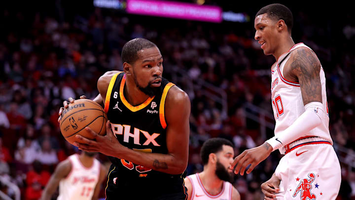 Dec 27, 2023; Houston, Texas, USA; Phoenix Suns forward Kevin Durant (35) rebounds against Houston Rockets forward Jabari Smith Jr. (10) during the first quarter at Toyota Center. Mandatory Credit: Erik Williams-Imagn Images