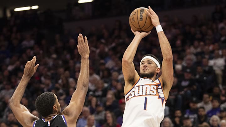 November 13, 2024; Sacramento, California, USA; Phoenix Suns guard Devin Booker (1) shoots the basketball against Sacramento Kings forward Keegan Murray (13) during the third quarter at Golden 1 Center. Mandatory Credit: Kyle Terada-Imagn Images