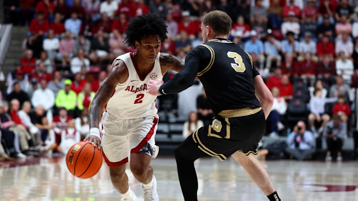 Nov 13, 2025; Tuscaloosa, Alabama, USA; Alabama Crimson Tide guard Aden Holloway (2) dribbles against Purdue Boilermakers guard Braden Smith (3) during the second half at Coleman Coliseum. Mandatory Credit: David Leong-Imagn Images