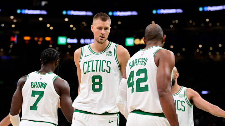 Oct 8, 2023; Boston, Massachusetts, USA; Boston Celtics center Kristaps Porzingis (8) reacts to game action with guard Jaylen Brown (7) and center Al Horford (42) during the first half at TD Garden. Mandatory Credit: Eric Canha-Imagn Images