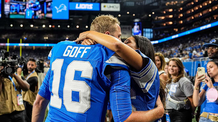 Detroit Lions quarterback Jared Goff hugs his wife Christen Harper during warmups before the Los Angeles Rams game at Ford Field in Detroit on Sunday, Sept. 8, 2024.