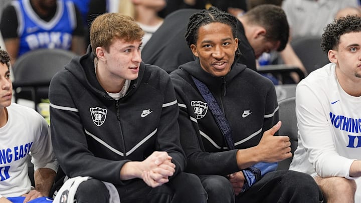 Mar 14, 2025; Charlotte, NC, USA; Duke basketball forward Cooper Flagg (2) and forward Maliq Brown (6) on the bench during the first half against the North Carolina Tar Heels at Spectrum Center. 