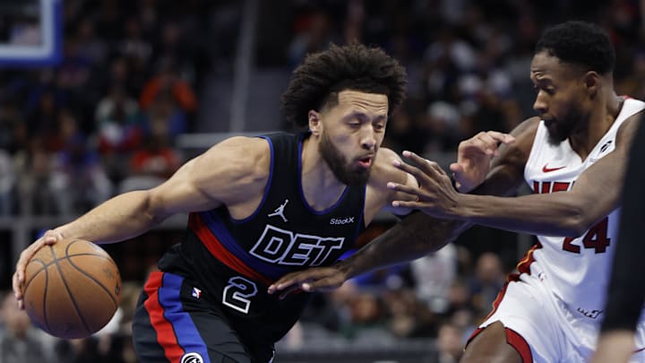 Nov 12, 2024; Detroit, Michigan, USA;  Detroit Pistons guard Cade Cunningham (2) dribbles defended by Miami Heat forward Haywood Highsmith (24) in the second half at Little Caesars Arena. Mandatory Credit: Rick Osentoski-Imagn Images