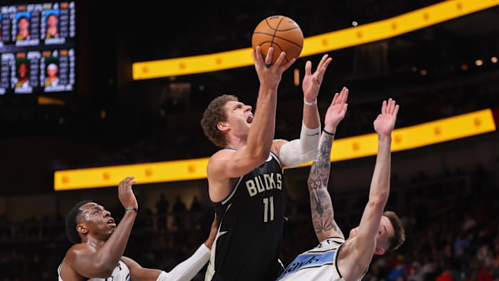 Feb 7, 2025; Atlanta, Georgia, USA; Milwaukee Bucks center Brook Lopez (11) shoots past Atlanta Hawks forward Onyeka Okongwu (17) and guard Vit Krejci (27) in the second quarter at State Farm Arena. Mandatory Credit: Brett Davis-Imagn Images Feb 7, 2025; Atlanta, Georgia, USA; Milwaukee Bucks center Brook Lopez (11) shoots past Atlanta Hawks forward Onyeka Okongwu (17) and guard Vit Krejci (27) in the second quarter at State Farm Arena. Mandatory Credit: Brett Davis-Imagn Images