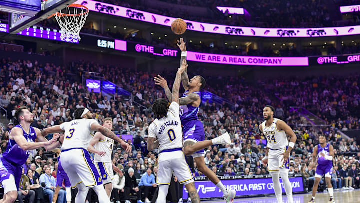 Dec 1, 2024; Salt Lake City, Utah, USA; Utah Jazz forward/center John Collins (20) gets fouled by Los Angeles Lakers guard Jalen Hood-Schifino (0) during the first half at the Delta Center. Mandatory Credit: Christopher Creveling-Imagn Images Dec 1, 2024; Salt Lake City, Utah, USA; Utah Jazz forward/center John Collins (20) gets fouled by Los Angeles Lakers guard Jalen Hood-Schifino (0) during the first half at the Delta Center. Mandatory Credit: Christopher Creveling-Imagn Images