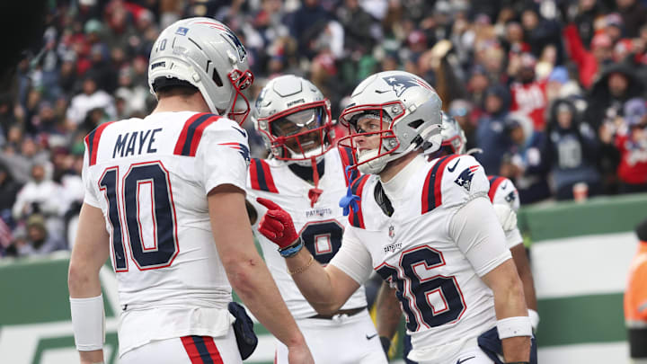 Dec 28, 2025; East Rutherford, New Jersey, USA; New England Patriots wide receiver Efton Chism III (86) celebrates his touchdown catch against the New York Jets with New England Patriots quarterback Drake Maye (10) during the second half of the game at MetLife Stadium. Mandatory Credit: Vincent Carchietta-Imagn Images