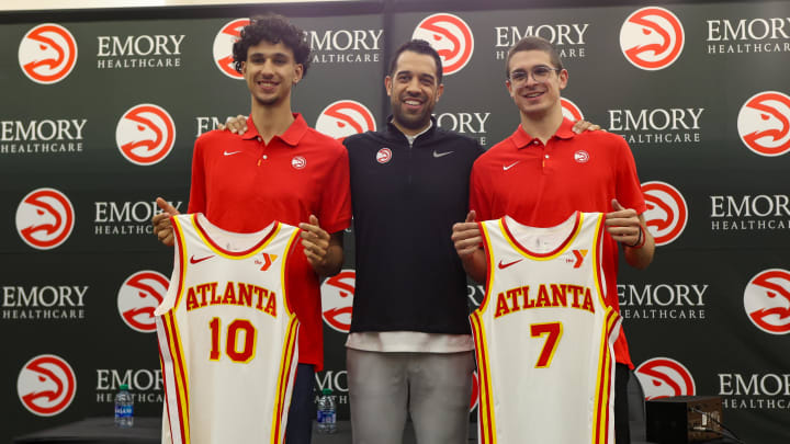 Jun 28, 2024; Atlanta, Georgia, USA; Atlanta Hawks first overall draft pick Zaccharie Risacher and general manager Landry Fields and second round draft pick Nikola Djurisic pose for a photo with jerseys at the Emory Sports Medicine Complex. Mandatory Credit: Brett Davis-USA TODAY Sports