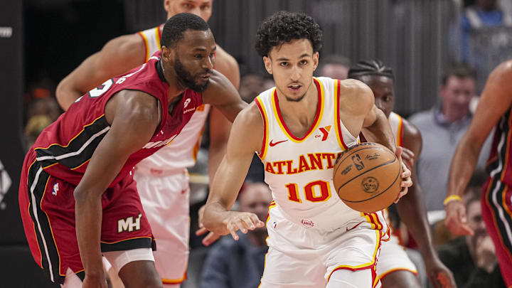 Feb 24, 2025; Atlanta, Georgia, USA; Atlanta Hawks forward Zaccharie Risacher (10) steals the ball from Miami Heat forward Andrew Wiggins (22) during the second half at State Farm Arena. Mandatory Credit: Dale Zanine-Imagn Images