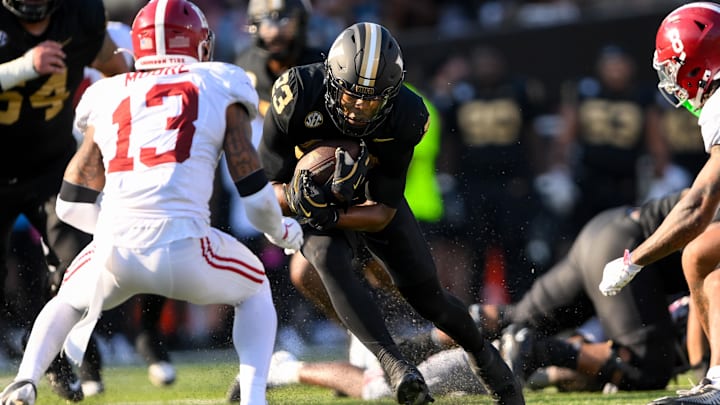 Oct 5, 2024; Nashville, Tennessee, USA;  Alabama Crimson Tide defensive back Malachi Moore (13) tackles Vanderbilt Commodores running back AJ Newberry (23) during the first half at FirstBank Stadium. Mandatory Credit: Steve Roberts-Imagn Images