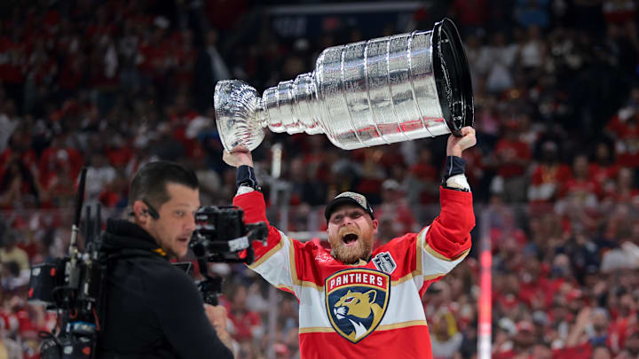 Jun 17, 2025; Sunrise, Florida, USA; Florida Panthers center Sam Bennett (9) hoists the Stanley Cup after winning game six of the 2025 Stanley Cup Final against the Edmonton Oilers at Amerant Bank Arena. 
