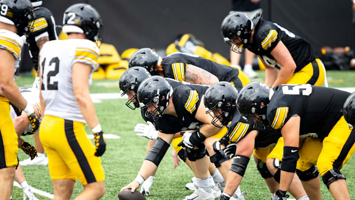 Aug 9, 2025; Iowa offensive lineman Logan Jones (65) gets set to snap the ball during the Hawkeyes Kids Day NCAA football open practice at Kinnick Stadium in Iowa City, Iowa. Mandatory Credit: Joseph Cress for the Des Moines Register