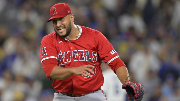 Jun 21, 2024; Los Angeles, California, USA;  Los Angeles Angels relief pitcher Carlos Estevez (53) reacts after striking out Los Angeles Dodgers second baseman Gavin Lux (9) in the 10th inning earning a save in the game at Dodger Stadium