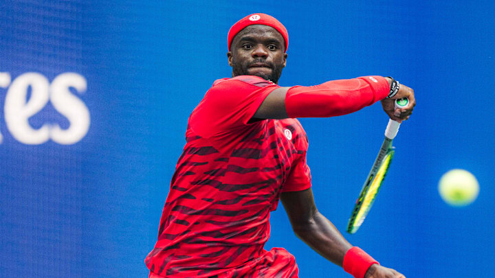 Frances Tiafoe plays his first round match at the U.S. Open in a bright red lululemon kit.